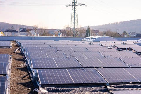 Extensive view of a roof installation with solar panels in an urban area, PV installation at OBI