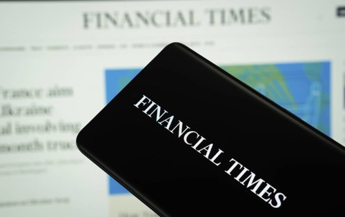 The logo of the newspaper Financial times is displayed on a smartphone screen, and the website