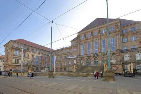 Town hall built in 1909 with EU flag, German national flag, Hessian state flag and city flag,