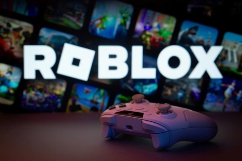Dhaka, Bangladesh- 26 July 2025: A close-up of a white gamepad with The Roblox seen on screen in