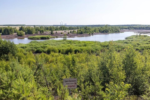 Viewpoint at the still flooded Bergener See with Sperrschidl, in the background the towers of the