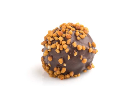 Chocolate caramel ball candy with almonds isolated on white background. Side view, close up