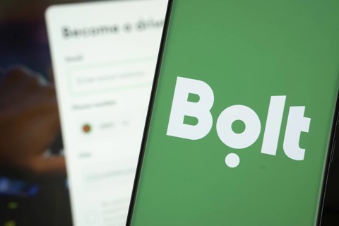 Bolt logo is displayed on a smartphone screen, with the bolt website visible on a computer screen