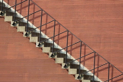 Staircase at the portico, red house façade with stairs and railing, linear fine geometric