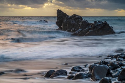 Sunset, waves and rocks in the sea, Praia Formosa, Madeira, Portugal