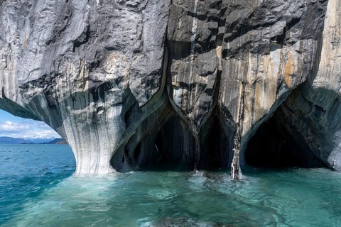 Marble caves (Capillas de Mármol) with striped rock formations over turquoise-coloured water,
