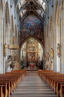 The magnificent carved altar made of linden wood with the choir arch fresco in Überlingen Münster,