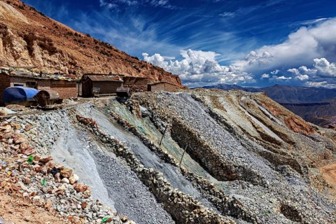 Dramatic rock formations rise to the sky along a dry landscape, the silver mines near Potosi on