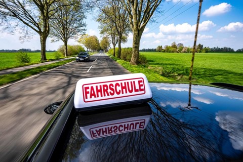 Symbolic picture driving school driving on a country road