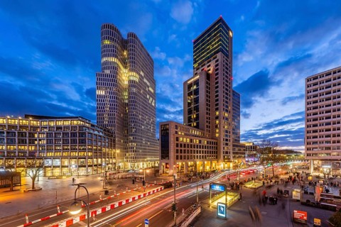 Zoofenster Berlin in the evening. Skyscrapers of the Hotel Waldorf Astoria and Upper West with the