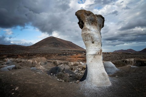 Eroded rock formations, volcanic landscape with dramatic cloudy skies, Ciudad Estratificada or Los