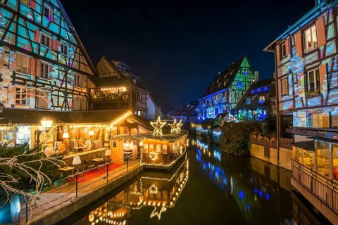 Colourfully illuminated and Christmassy decorated half-timbered houses, old town, blue hour,