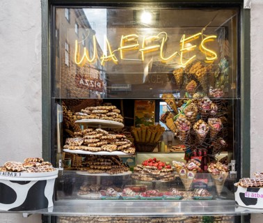 Shop window full of waffles and sweets at Västerlånggatan in the old town Gamla Stan in Stockholm,