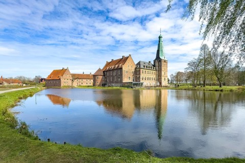 View over moat at historic moated castle from Renaissance Raesfeld Castle reflected in Wassergraben