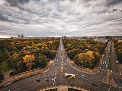 An impressive panorama of Berlin with an autumn avenue and cloudy sky, view from the Victory