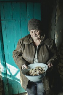 Larisa in her house in Borshchivka. The village was under Russian occupation. She hid in her house