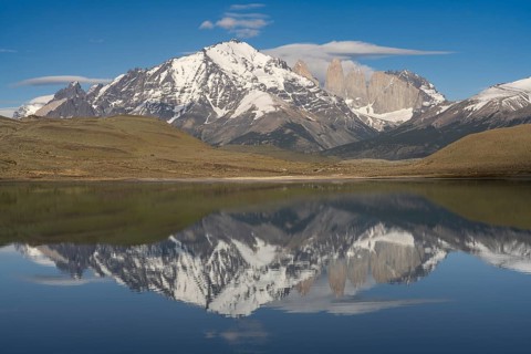 Torres del Paine granite towers with snow-covered mountain range, reflection in Amarga lagoon,