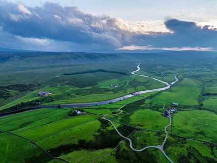 Forest in Teesdale over River Tees from a drone, North Pennines AONB, County Durham, England,