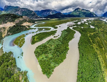 Aerial view over the branches of river Rio Ibanez, wide river landscape, muddy and blue glacial