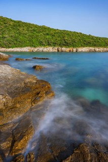 Crystal clear and turquoise water on the beach of Ustrine Bay on a sunny day on the island of Cres,