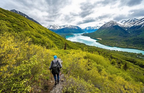 Climbers on a hiking trail, Slaughter Ridge Trail, view of snowy mountains in spring and turquoise
