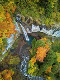 Aerial view of Berglistüber waterfall in autumn-colored surroundings, Linthal, Klausenpass, Canton