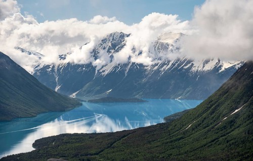 View of snowy mountains in spring and turquoise Kenai Lake with reflection, Slaughter Ridge Trail,