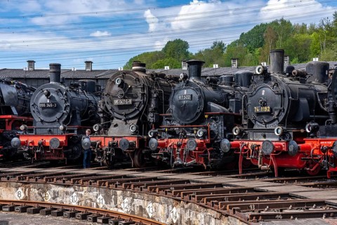 Ring locomotive shed with many historic steam locomotives in the Bochum Railway Museum, museum days