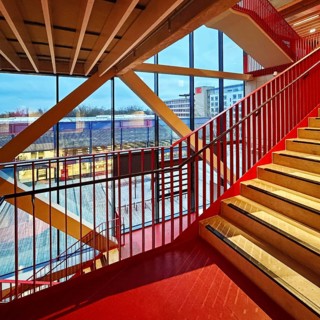 Staircase with signal red color scheme in seminar building H of Bochum University in the evening
