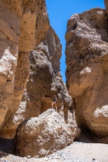 Tourist on a rock, Sesriem Canyon, Namib-Naukluft Park, Namibia