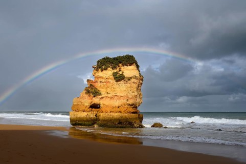 Rocks on beach with rainbow, Praia Dona Ana, Lagos, Algarve, Portugal