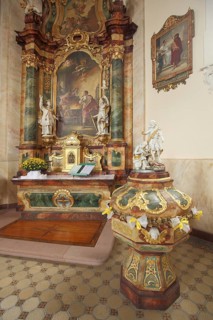 Magnificent high altar and baptismal font, baroque St. Martin church, handicrafts, decorations,