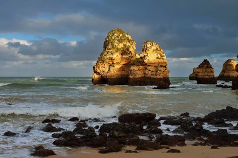Rock formations on the coast in the evening light, Praia do Camilo, Lagos, Algarve, Portugal