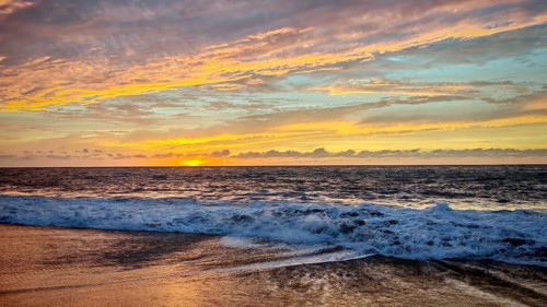 Play of colors in the sky during sunset at sea with soft waves, romantic, Tarrafal de Monte Trigo,