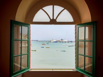 View of the sea through an open window with boats in a quiet atmosphere, Torre de Belem, Mindelo,