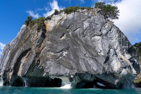 Marble rocks with washed out caves over turquoise water, Capillas de Mármol, Lago General Carrera,