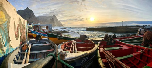 Boats in a colorful harbor illuminated by sunset light, graffiti, romantic harbor scene, Ponta do