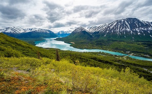 View of snowy mountains in spring and turquoise blue Kenai Lake, Slaughter Ridge Trail, Cooper