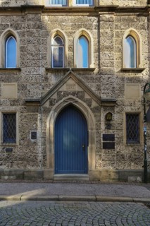 Entrance, blue wooden door, lodge sign, writing, letters, information board at the Marchtaler Hof,
