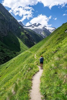 Mountaineer on a hiking trail in Umbaltal, Venediger Group, Hohe Tauern National Park, East Tyrol,