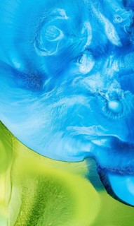 A vivid and dynamic abstract image showcasing swirling liquid inks in rich shades of blue and