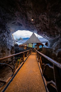 Rustic bridge in an illuminated cave restaurant with natural flair, St. Beatus Caves, Switzerland