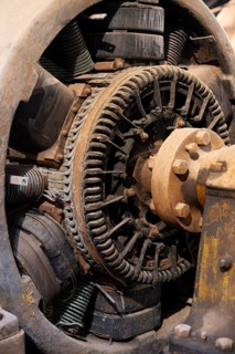 Old generator with rotor, copper windings and coupling flange, detailed view of a historic
