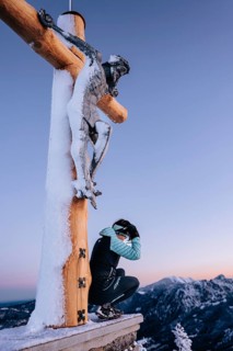 Summit bliss in the snow-covered winter landscape in the Tannheimer Tal in the Alps on the