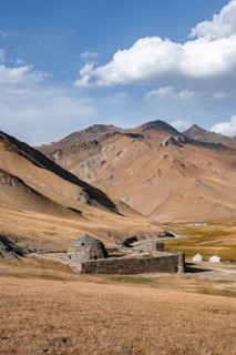 Historic caravanserai Tash Rabat from the 15th century, with yellow hills, Atbashy district in the