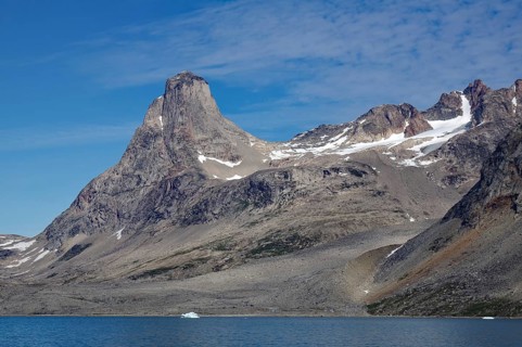 Majestic steep mountains with rock formations on the shore of a fjord, Tasilaq, Arctic, Greenland,