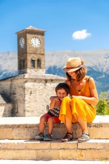 Mother and son having fun at the Clock Tower in the Ottoman Castle Fortress of Gjirokaster or