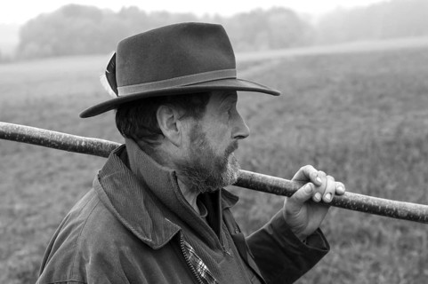 Portrait of a farmer with hat and stick herding his cattle, black and white, Middle Franconia,