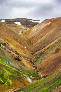 Small river between colourful rhyolite mountains, volcanic landscape, erosion landscape,