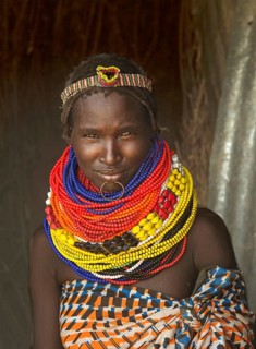 Young woman of the Karo ethnic group wears colourful bead necklaces around her neck, Southern Omo